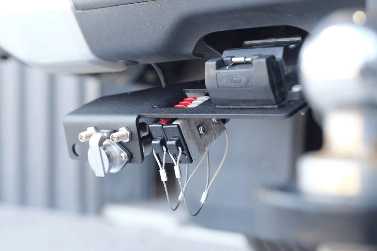 Accelerate Off-Grid Touring trailer bracket installed on a Ford Ranger Super Duty, featuring an Anderson plug, 12-pin trailer socket, Safety Dave camera connection and a caravan-ready towing setup.